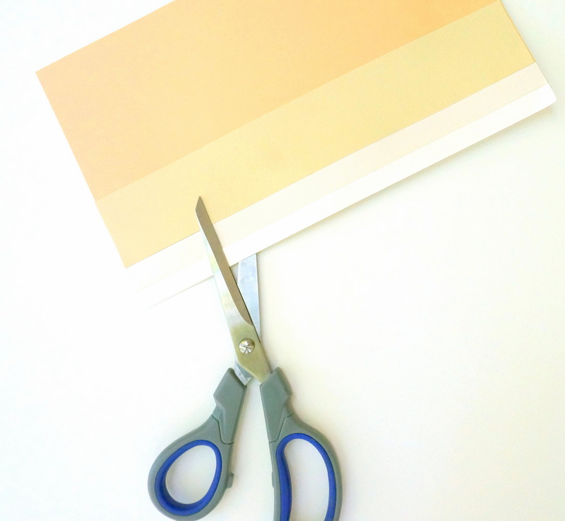 Glue strips of paper to a background page, then cut the shape of your choice