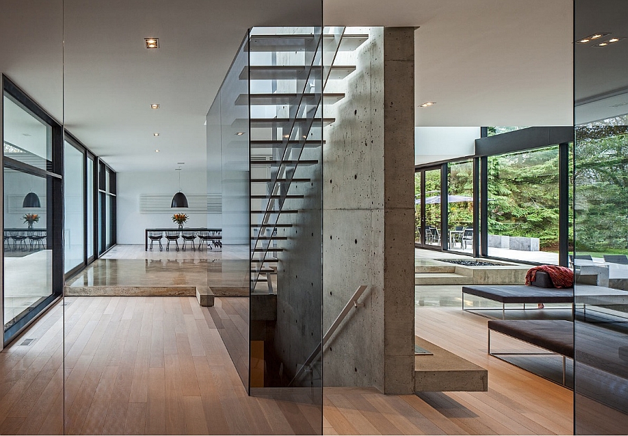 Gorgeous floating staircase set next to a concrete wall