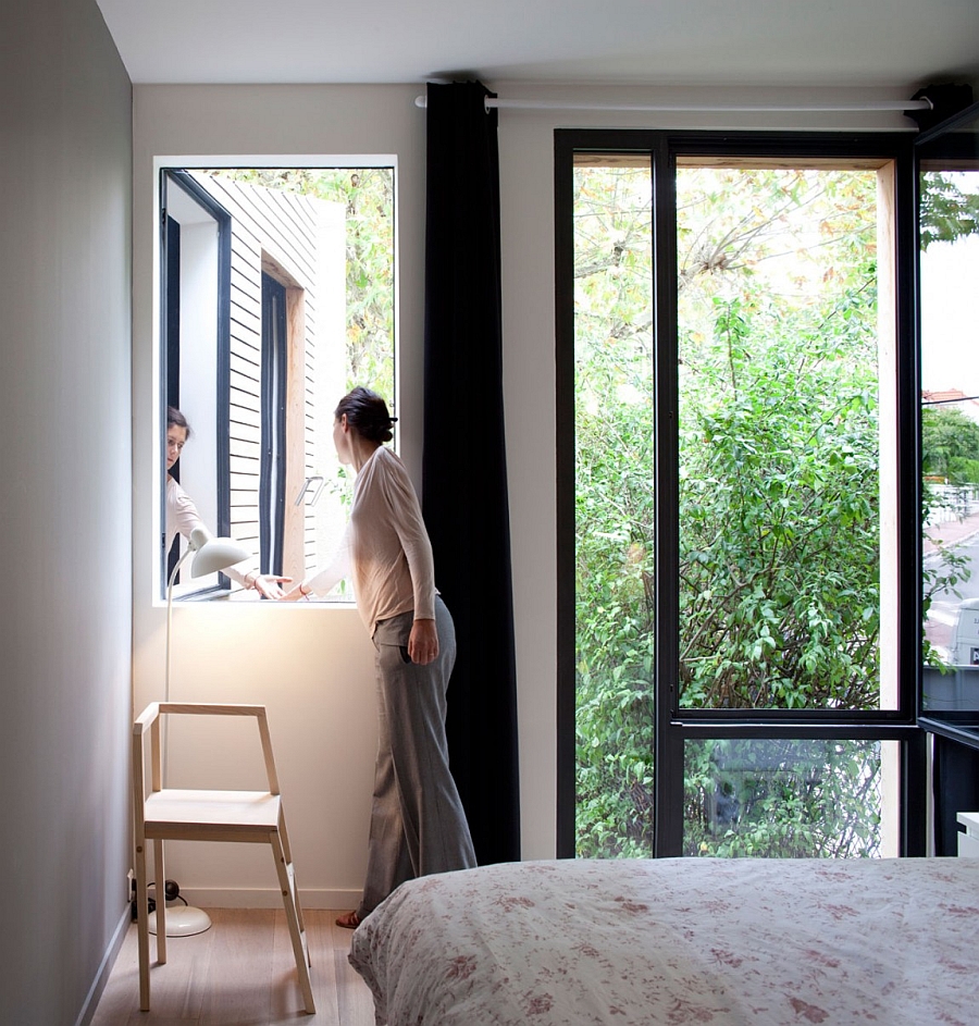 Greenery outside becomes a natural part of the bedroom