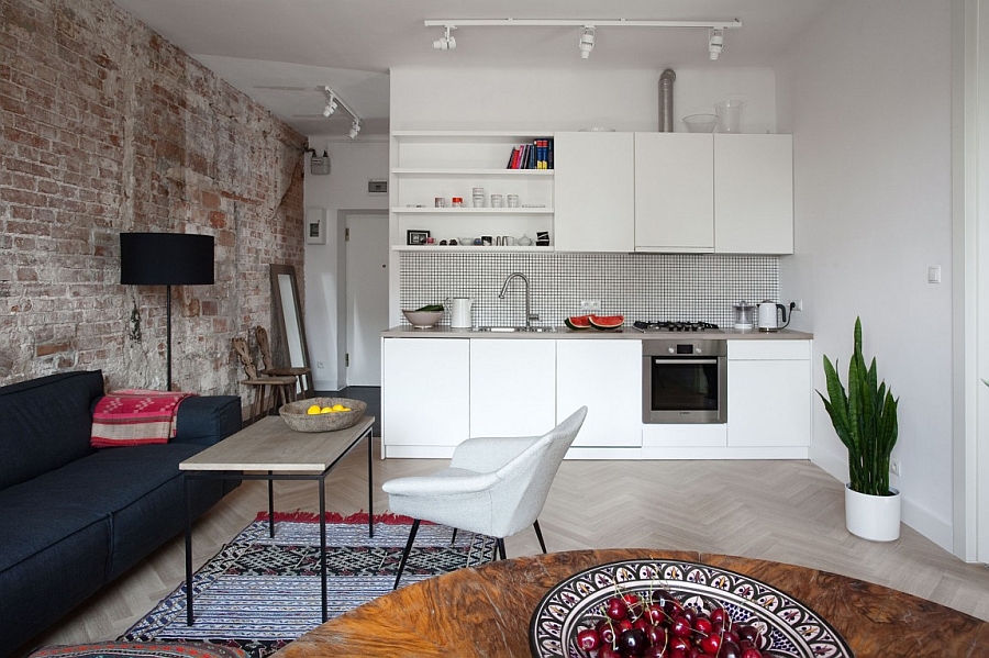 Herringbone pattern on the floor and kitchen backsplash add style to the interior