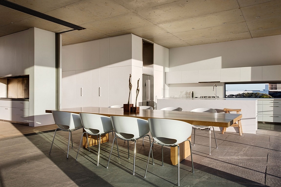 Large wooden dining table adds warmth and elegance to the open floor living space