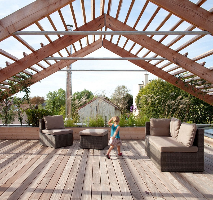 Lovely pergola looks like an unfinished roof as it houses a green vegetable and fruit garden