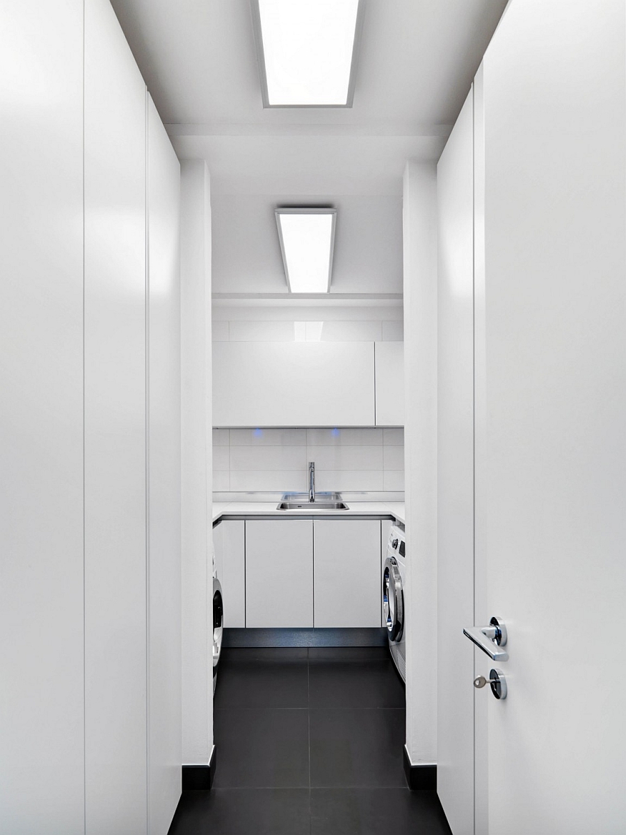 Minimal and space-conscious laundry room in white