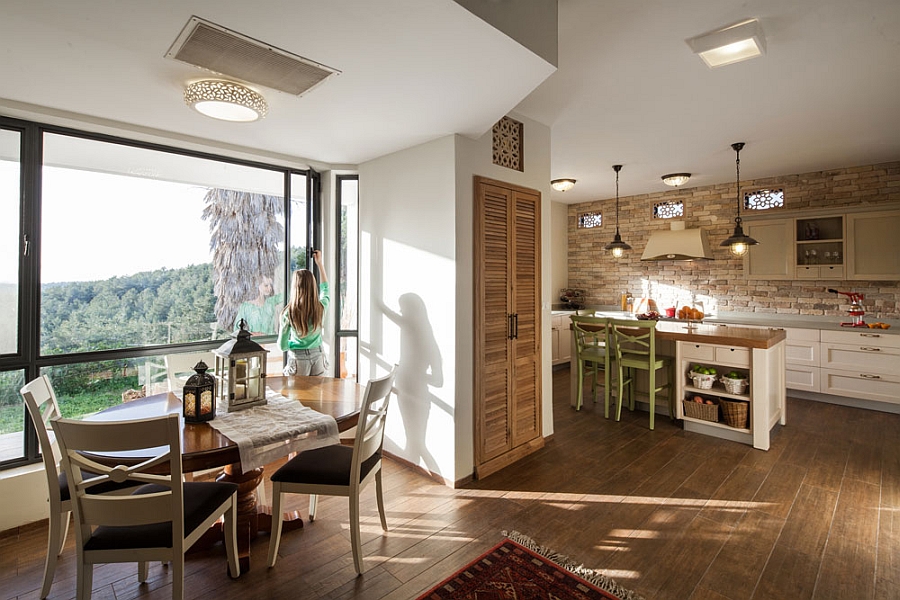 Natural stone and soothing colors define the beautiful kitchen and dining area