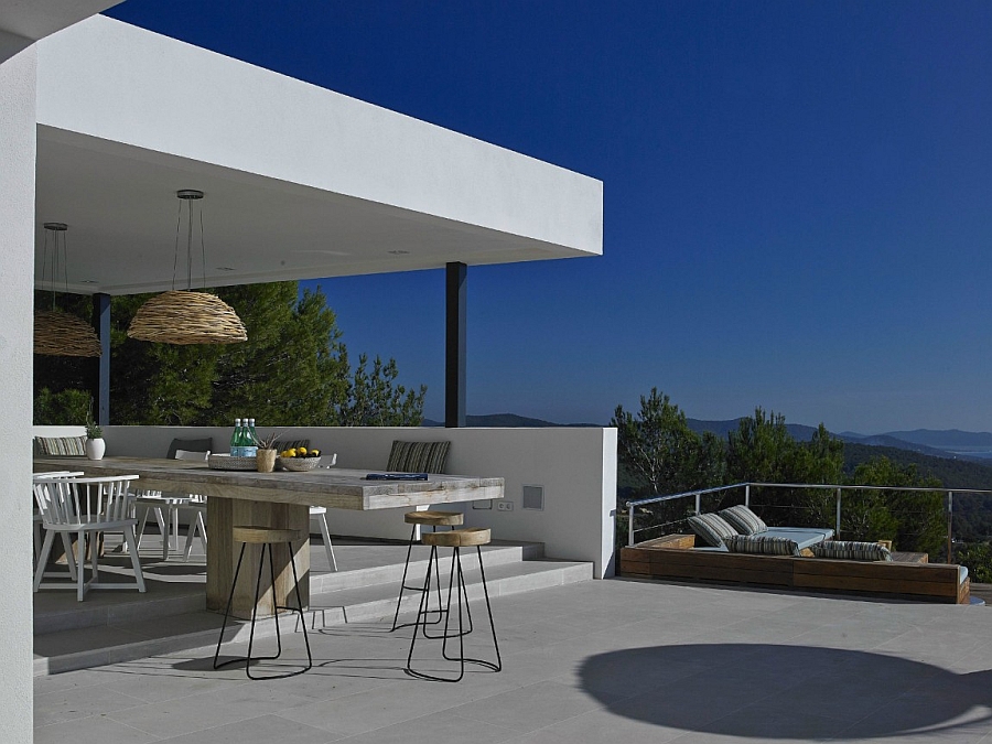 Outdoor dining area and lounge with a view of the distant mountains