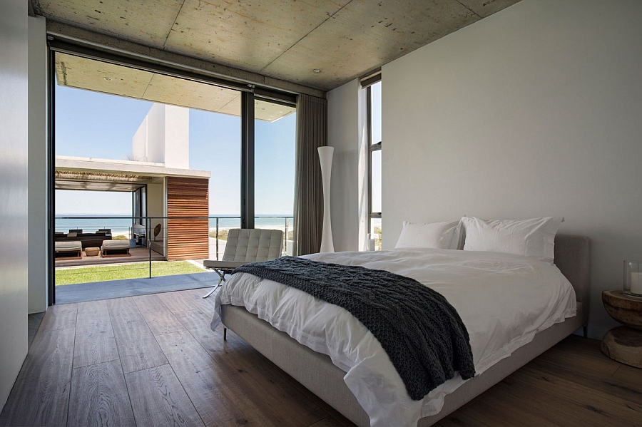 Serene bedroom overlooks the living area and the distant ocean