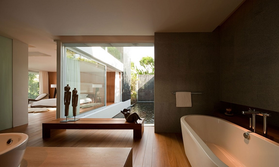 Stylish bath visually connected with the pond outdoors