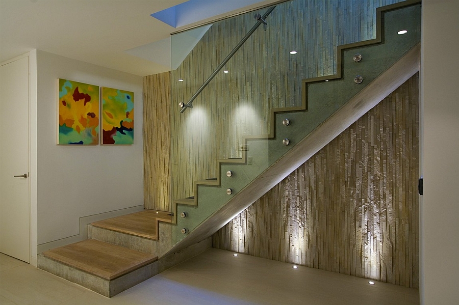 Textured wall behind the contemporary staircase with glass railing