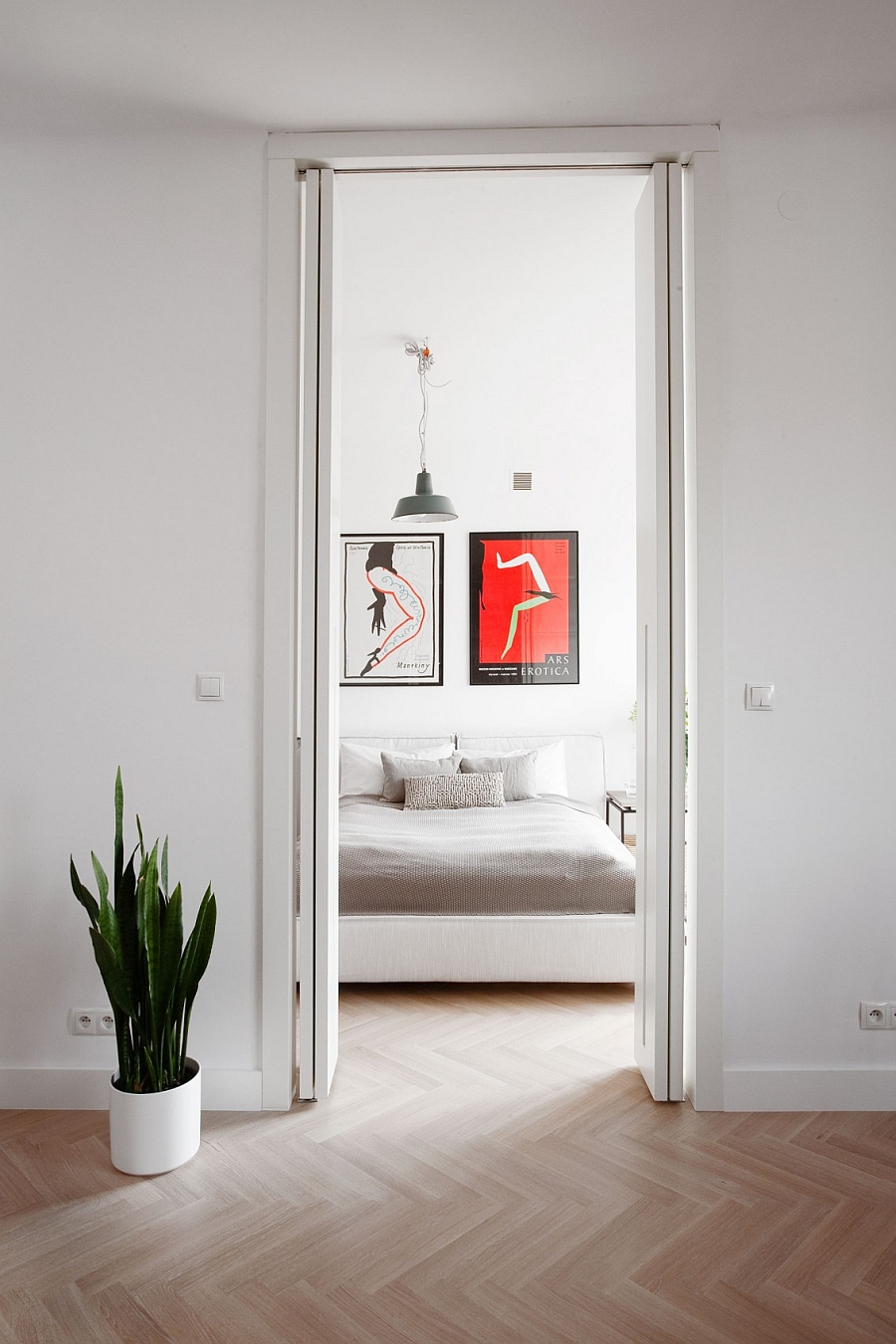 Vinatge Posters from the 70s and 80s add color to the contemporary bedroom