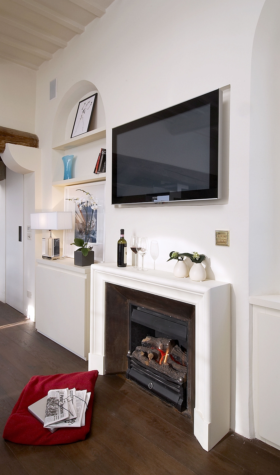 Wall-mounted television above the fireplace in the living room