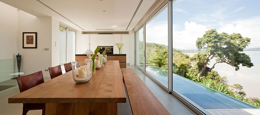 Wooden dining table complements the sleek wooden deck outside