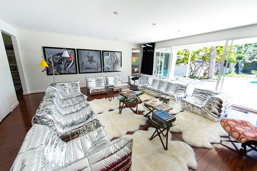 Chic silver sofas and plush rugs bring in the Hollywood Regency charm