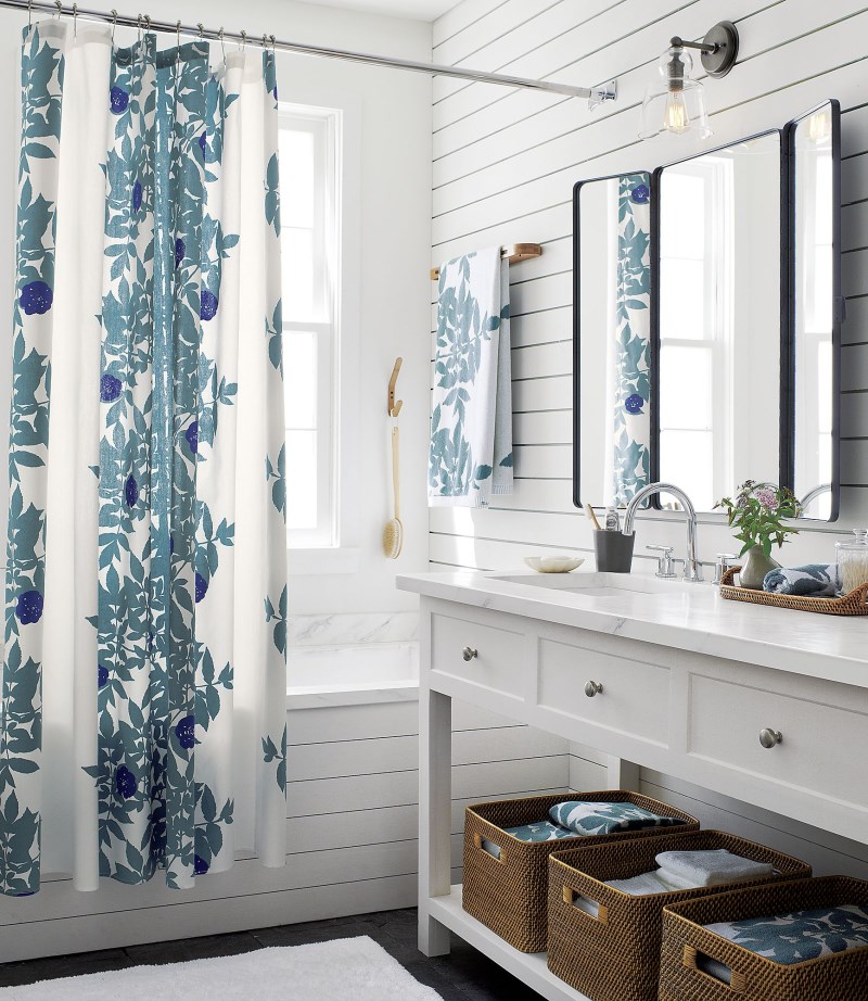 Crisp blue and white bedroom with Marimekko towels