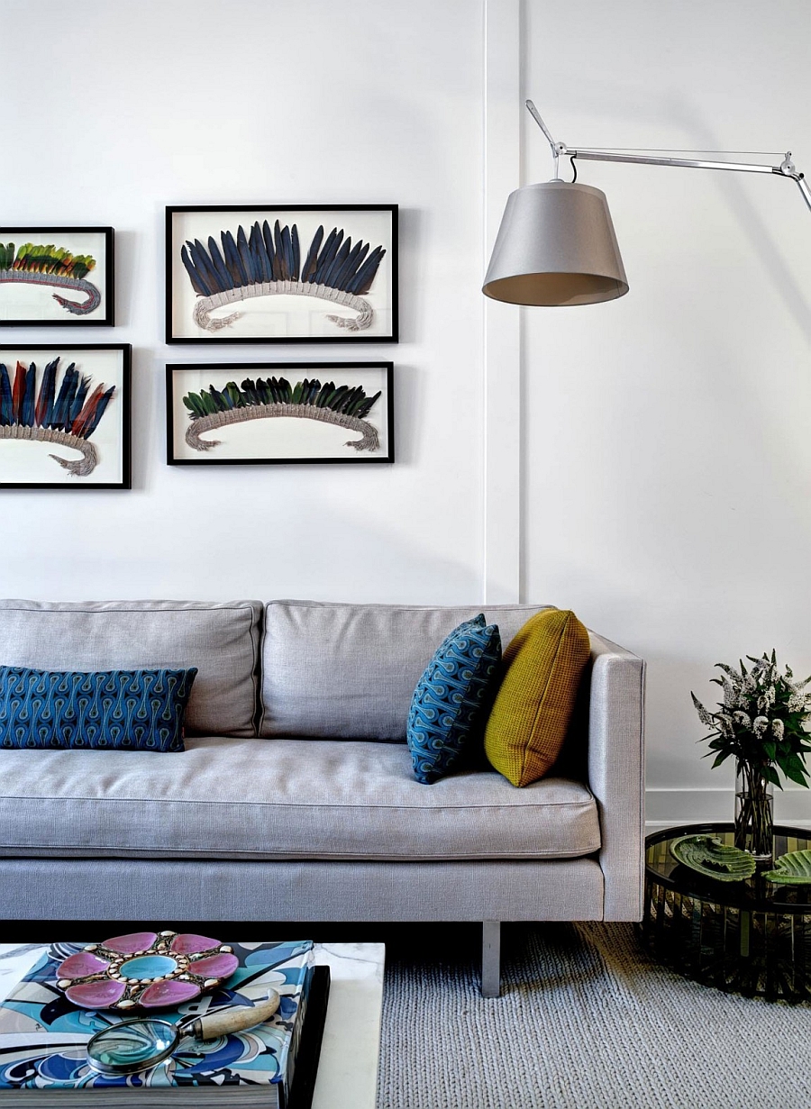 Framed wall art and accent pillows bring dashing color to the living room