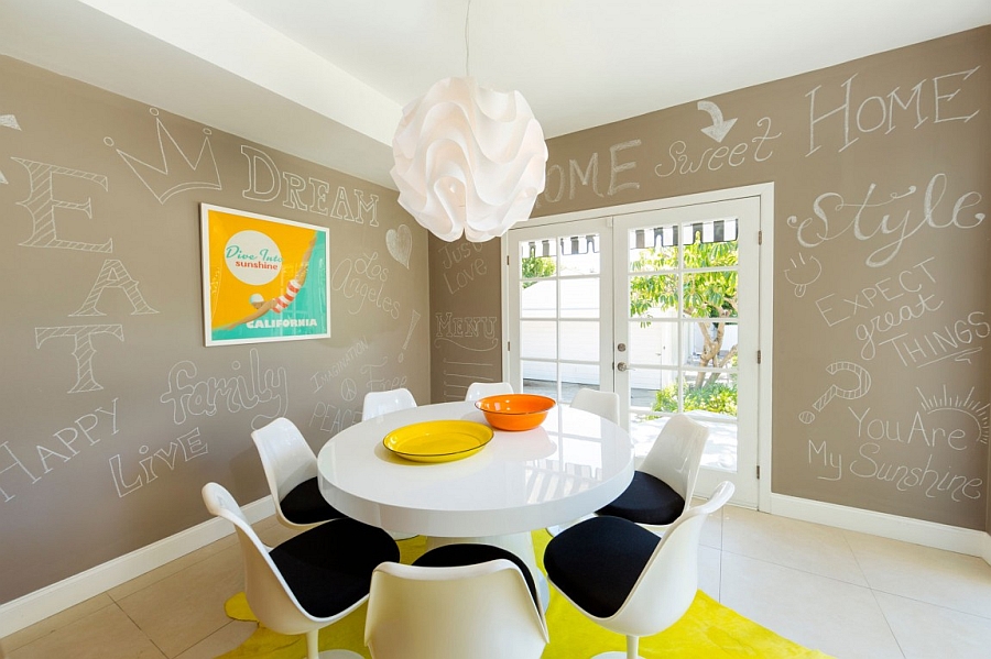 Fun pops of yellow and orange enliven the mid century modern dining