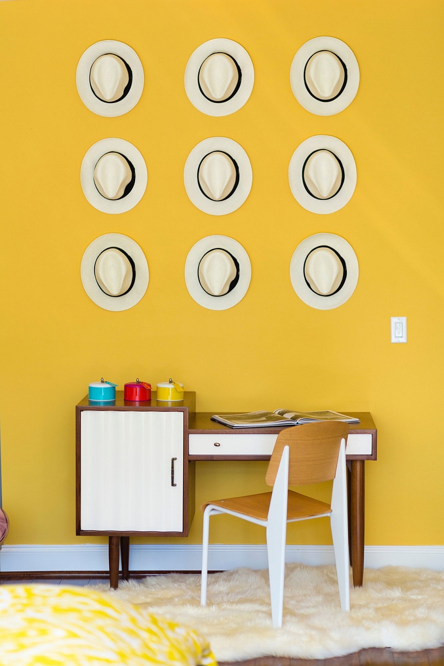 Home office with a collection of decorative hats on the wall