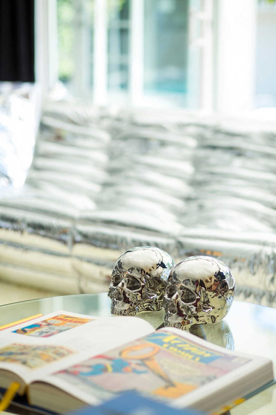 Interesting silver metallic skulls on the living room coffee table!