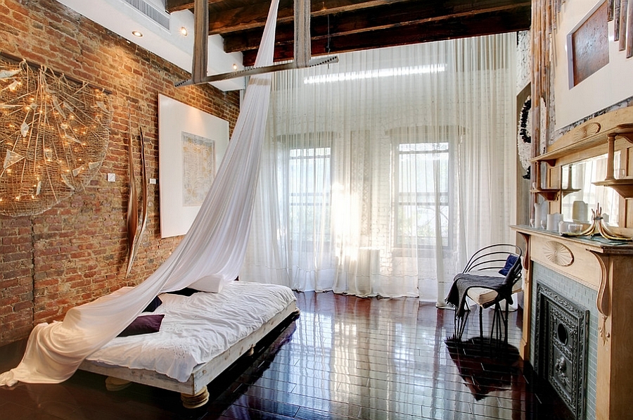 Loft-style bedroom with high ceiling, wooden beams and low-slung decor