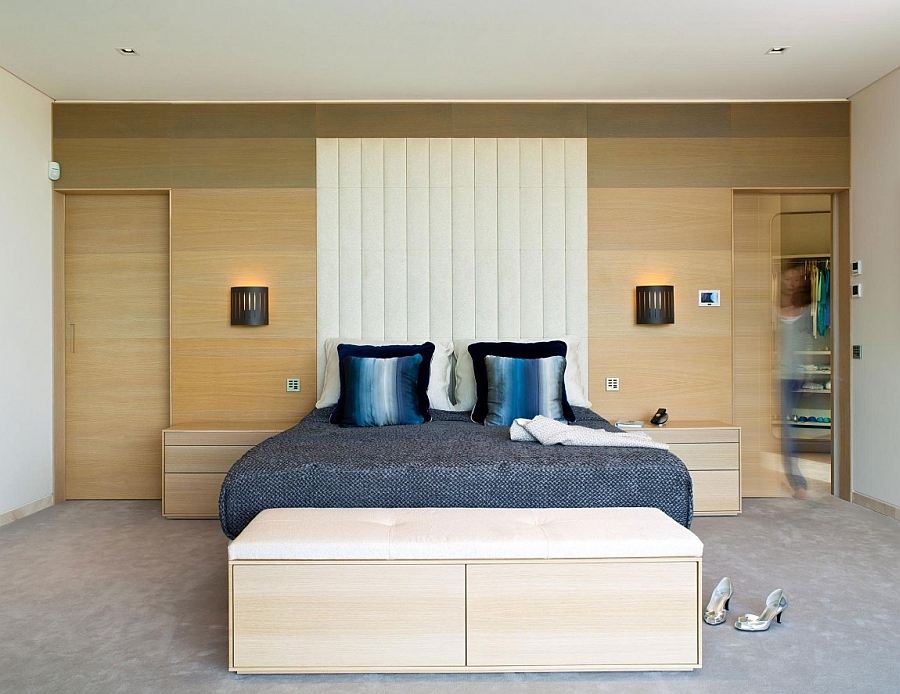 Modern bedroom with a walk-in closet and a wooden accent wall