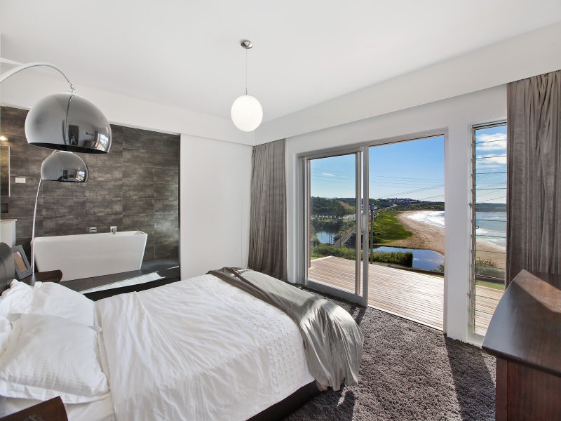 Modern bedroom with silvery tones and a view
