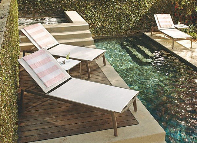 Peach and white striped towels by the pool