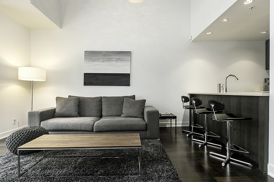 Plush couch in gray and corner floor lamp in the small living area