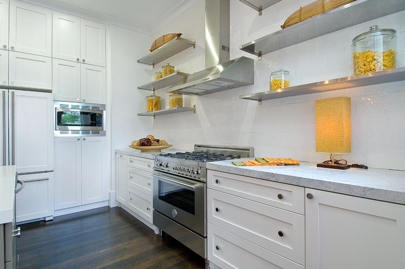 Shades of yellow on open stainless steel kitchen shelving