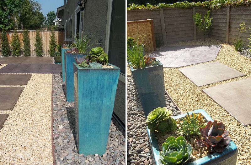 Turquoise planters in a landscaped yard