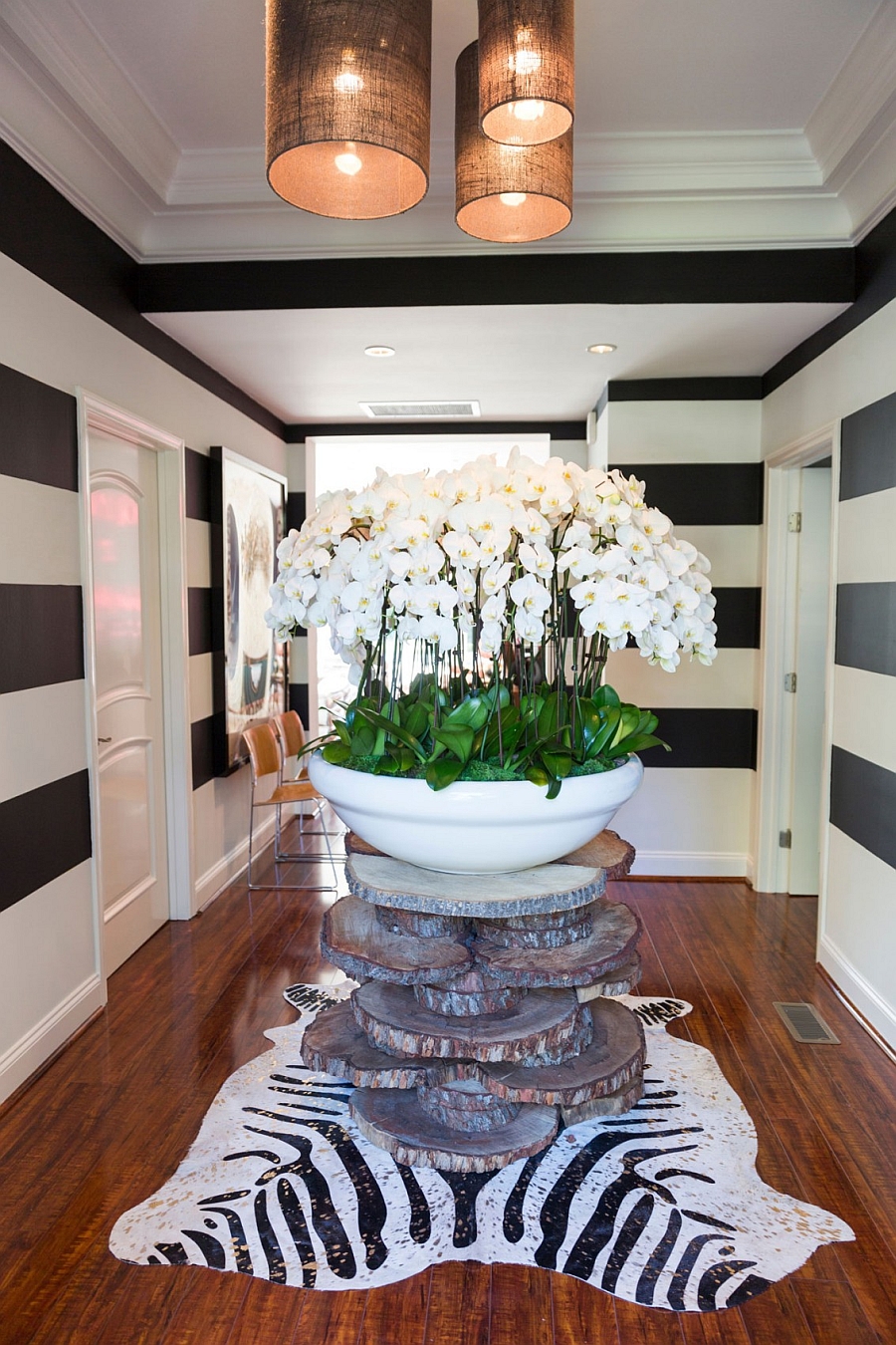 Vintage entrance with a giant vase and black and white stripes