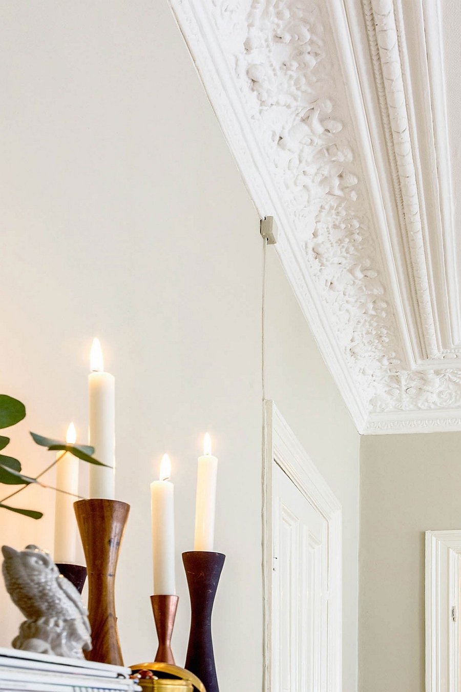 Wall ceiling and candles add sense of timeless style to the room