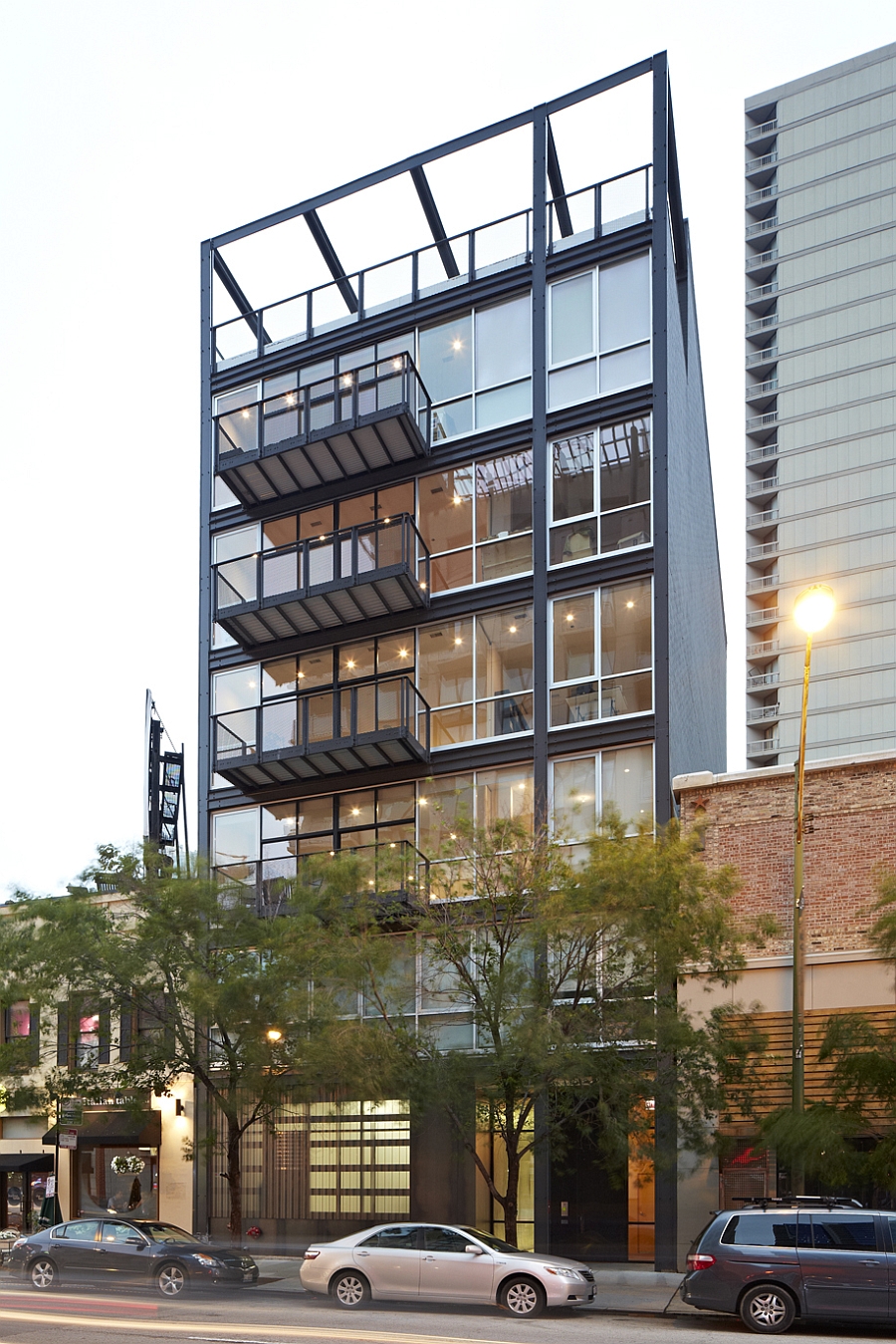 Warm lighting inside the condominiums adds to the overall appeal of the structure