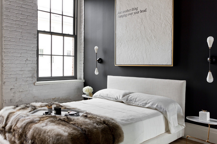 White brick and dark accent wall add contrast to the NYC apartment bedroom