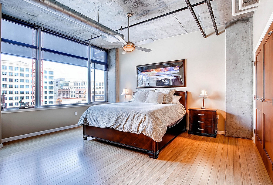 Wood, concrete and metal meet in this industrial style bedroom [Design: PorchLight Real Estate Group]