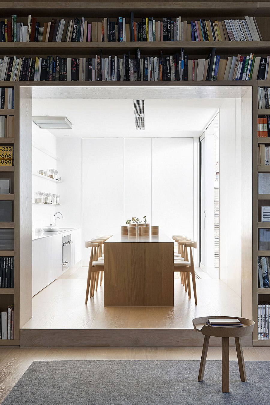 All white kitchen with wooden island at its heart