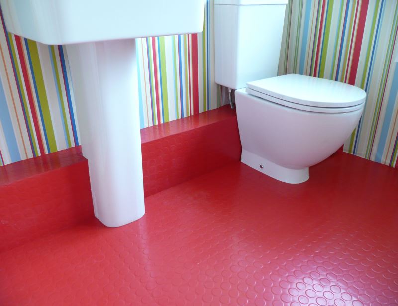 Bathroom with red rubber flooring