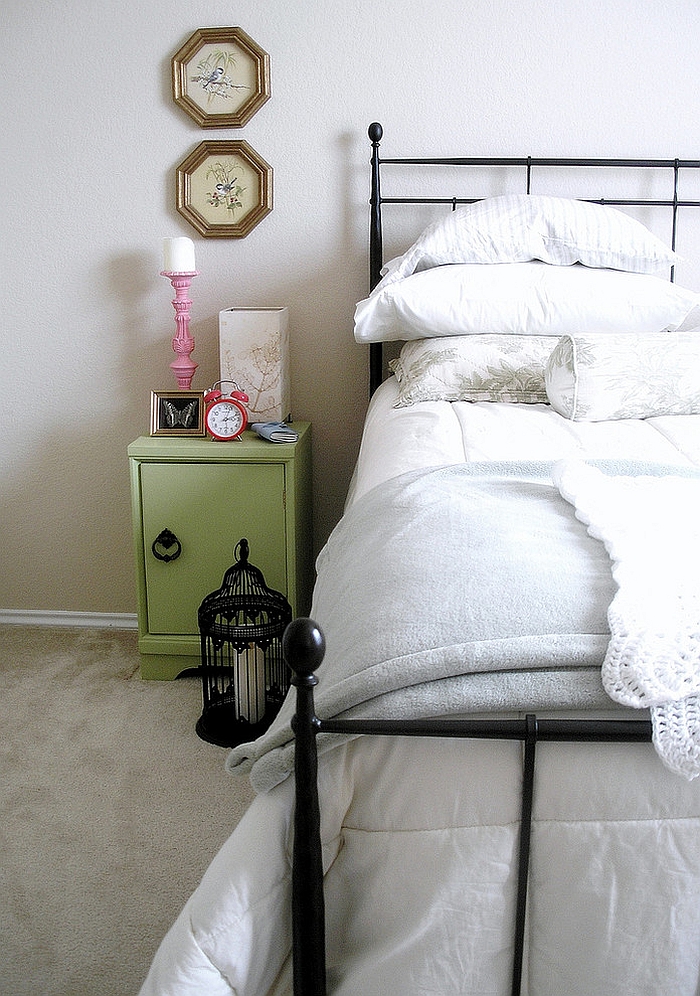 Birdcage with candle next to the bed!