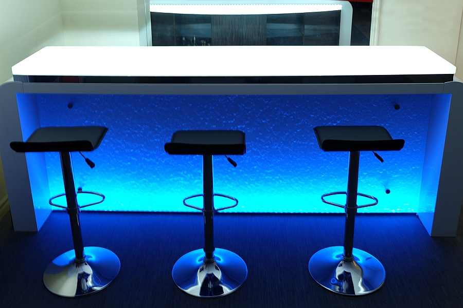 Blue LED lighting illuminates the stylish glass bar