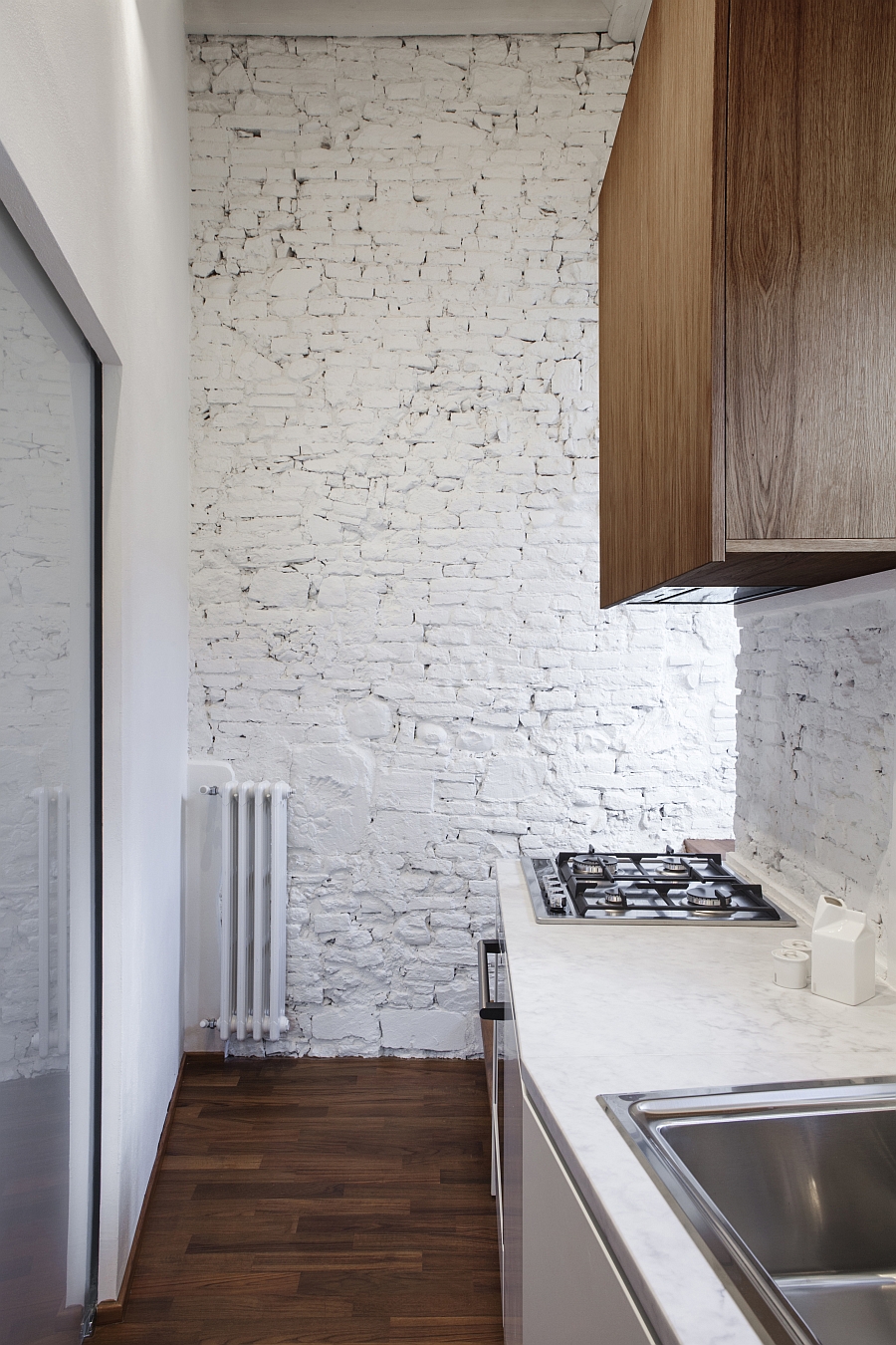 Bright and cheerful kitchen with painted brick walls and carrara marble countertop