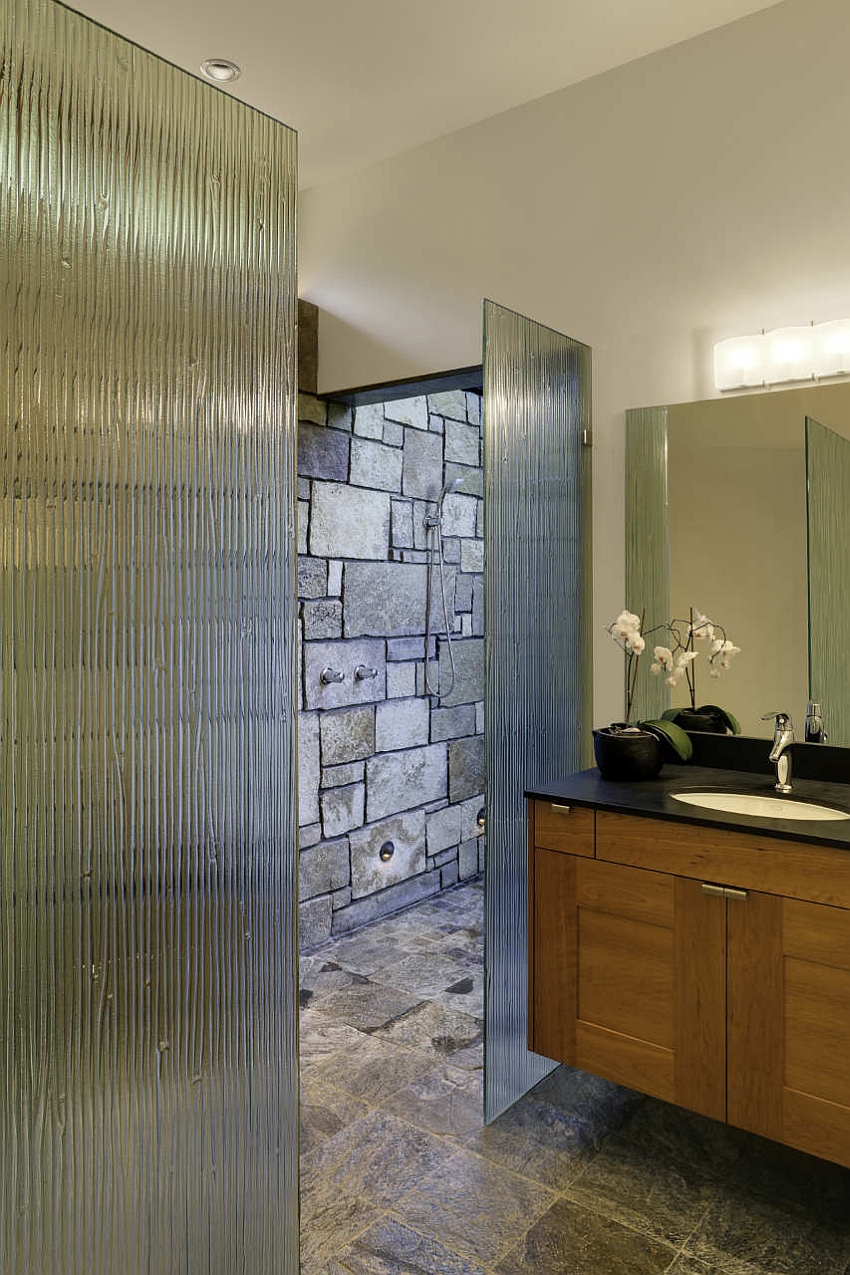 Contemporary bath with stone wall