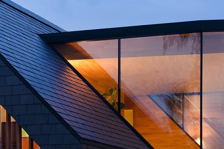 a triangle shaped window follows the lines of the roof on