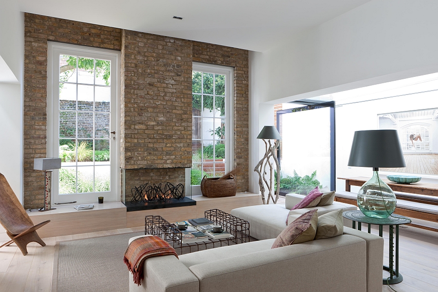 Eclectic living room with a brilliant fireplace and brick backdrop