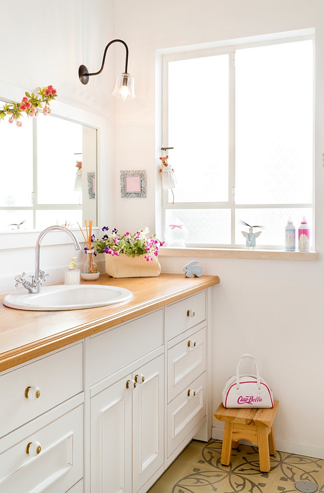 Flowers bring a touch of feminine charm to the eclectic bathroom [Design: Davidie Rozin Architects]