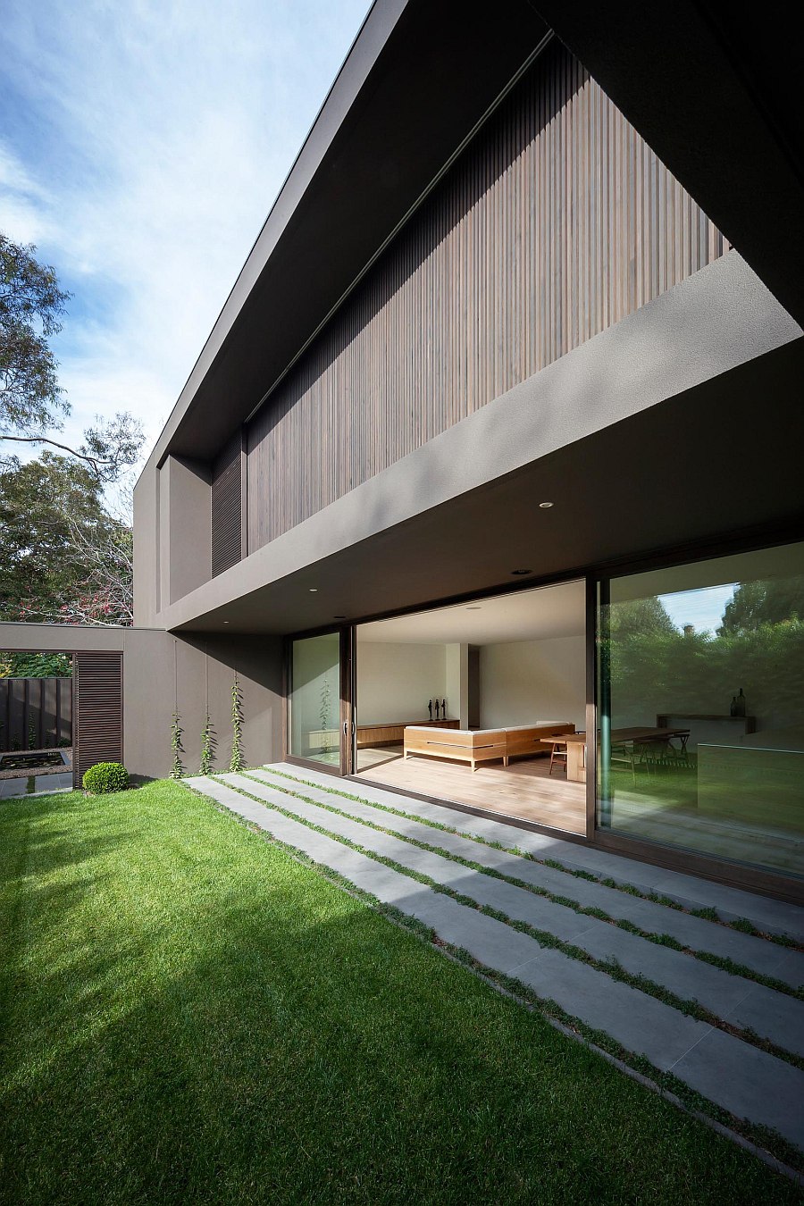 Large sliding glass doors connect the interior with the backyard