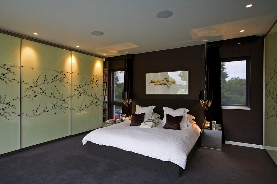Lavish master bedroom embraces a dark color scheme