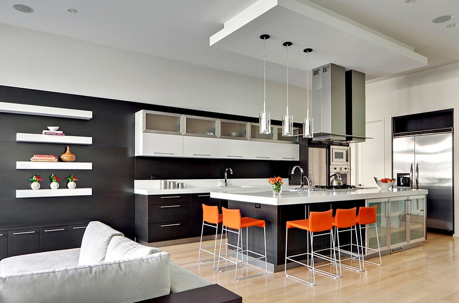 Minimalist kitchen with black with bright orange counter stools [By: MAY Designs]