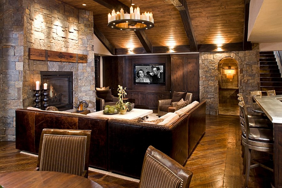 Natural stone and reclaimed timber shape the rustic living room [Design: John Kraemer & Sons]