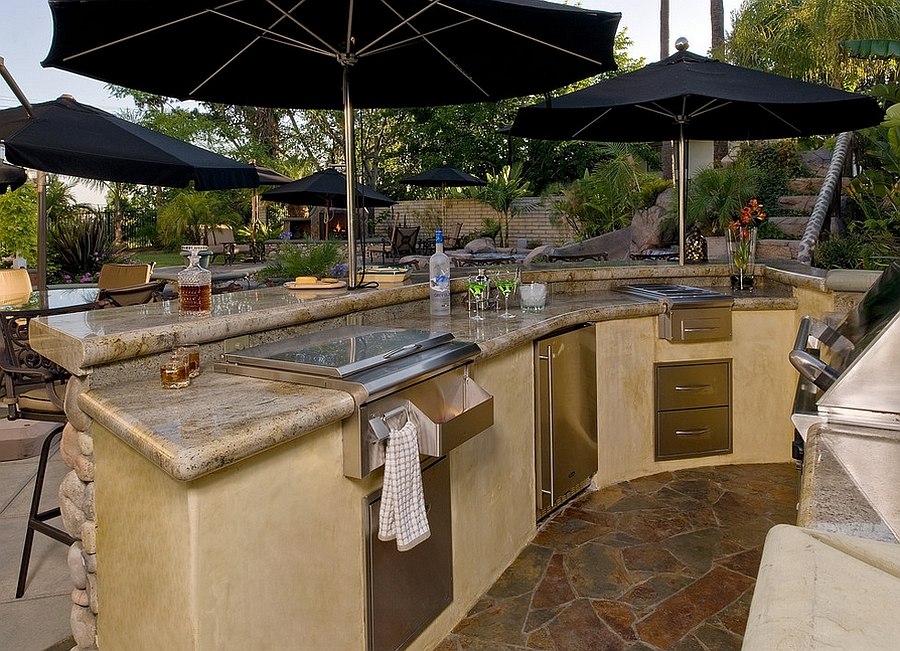 Smart use of umbrellas gives the kitchen ample shade [From: Steven Paul Whitsitt Photography]