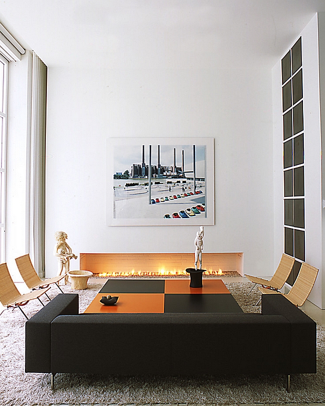 Sophisticated living room with black and orange decor additions [By: Shinberg Levinas]