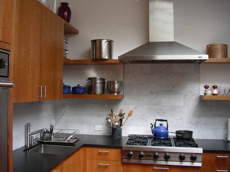 Stainless steel pots on open shelving in a contemporary kitchen