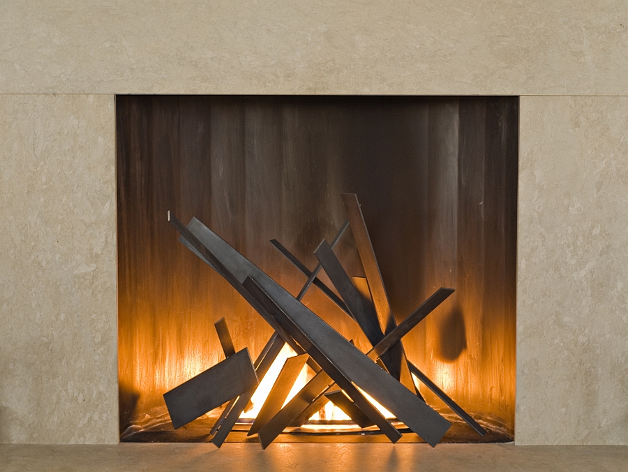 Tapering steel plates inside the fireplace bring geometric style to the room